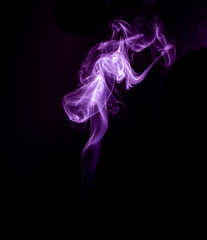 A realistic shot of a wisp of smoke against a black background - great for a cool background