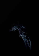 A realistic shot of a wisp of smoke against a black background - great for a cool background