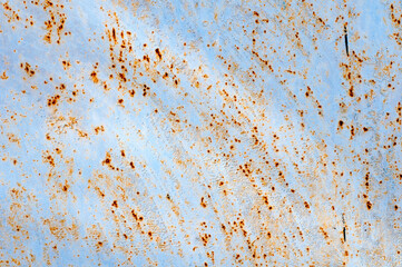 Background. Rusty metal surface. The blue paint was peeling. The iron is oxidized.