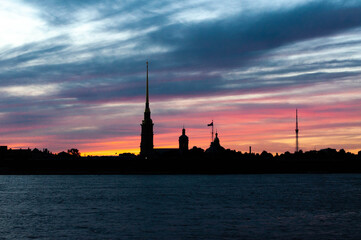 Black silhouette of the Peter and Paul Fortress at sunset. White night sky glow in Saint Petersburg, Russia.