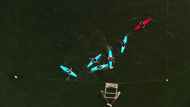 Aerial view. Water sport canoe polo. Team game kayak polo. Top view. Players on boats train on the river. Sports and recreation