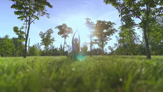 Young woman yoga outdoors keep calm and meditates while practicing yoga to explore the inner peace.