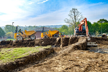array of earthmoving machinery on construction site