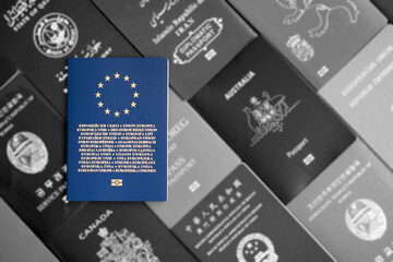 European Union biometric passport on monochrome background of many documents of different countries of the world