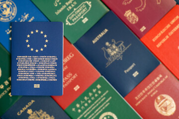 European Union biometric passport on blurred background of many documents of different countries of the world