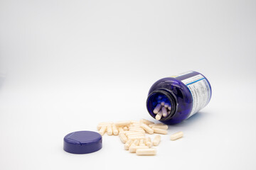 Medication in the form of capsules/pills/tablets against a white background