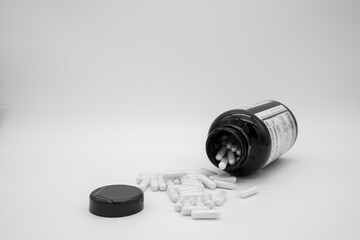 Medication in the form of capsules/pills/tablets against a white background