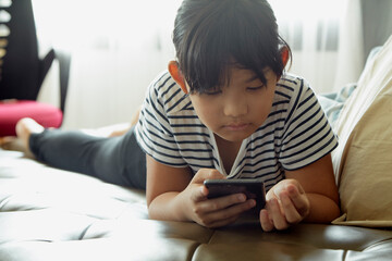 Little girl using smartphone at home