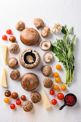 Fototapeta na wymiar Portabello mushrooms ingredients for baking, cheddar cheese, cherry tomatoes and sage on white background, top view.