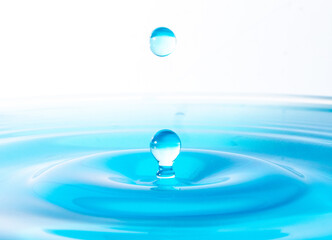 A water drop effect in purple blue  color tone in white background