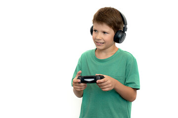 Teenager plays a computer game with headphones and a joystick, game console. Isolate