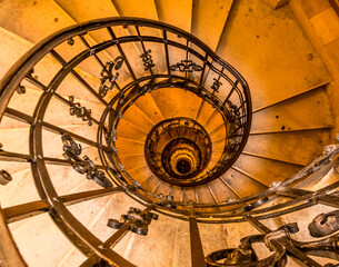 Fototapeta premium A view down a spiral staircase in Budapest in the summertime