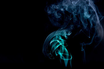 A closeup shot of  smoke swirls against a black background