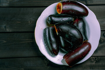 Eggplant in a plate on a wooden background