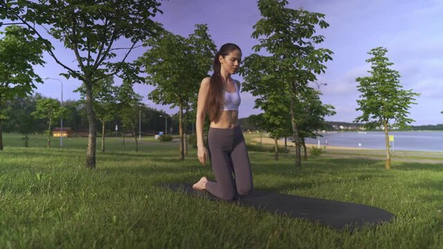 Young woman yoga outdoors keep calm and meditates while practicing yoga to explore the inner peace.