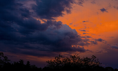Clouds under a crimson sky at sunset