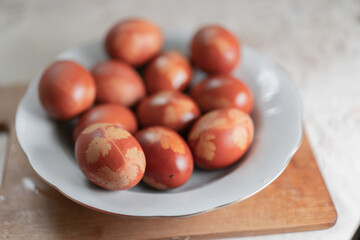 Painted eggs for Easter lie in a plate