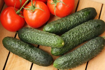 Fresh cucumbers and tomatoes on the table 