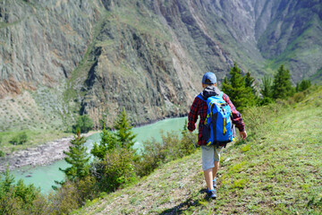 Fototapeta premium little hiker in the mountains