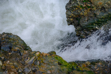 Stormy river flow over stones
