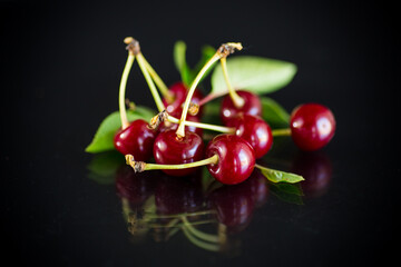ripe red natural cherry on a black