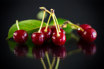 ripe red natural cherry on a black
