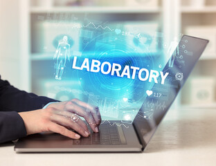 Doctor working a health check with LABORATORY inscription, recording medical test results