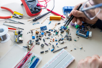 Guy holding electronic parts with his hand