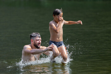 
Family vacation swimming in the summer season. The moment of immersion in water