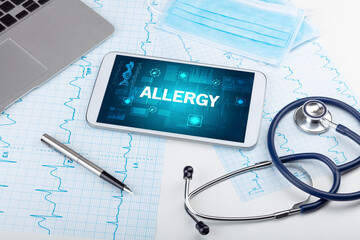 Tablet pc and medical stuff with ALLERGY inscription, prevention concept