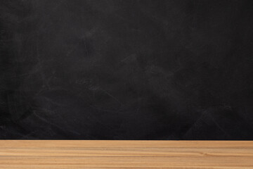 Back to school background. Wooden table and blank chalkboard background. Copy space