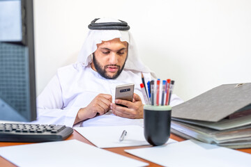 Arrabic muslim employee wasting his time on his smart phone