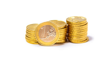 Cents, Euros, stocked in 3 piles close together with one euro coin on the front. from the front