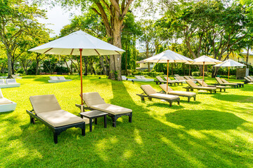 Umbrella and chair in garden for sun bathing