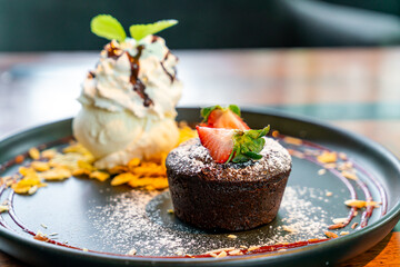 chocolate cake lava with strawberry and vanilla ice-cream