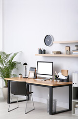 Modern computer on table in office interior. Stylish workplace