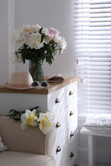 Bouquet of beautiful peony flowers in room