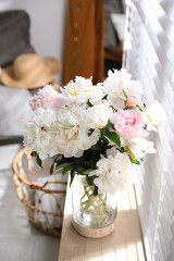 Bouquet of beautiful peony flowers on window sill indoors