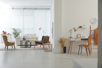 Living room and workplace in spacious apartment. Interior design