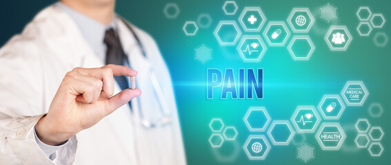 Close-up of a doctor giving you a pill with PAIN inscription, medical concept