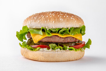 Tasty hearty Cheeseburger with meat cutlet, cheese and herbs for take away or food delivery isolated on a white background.