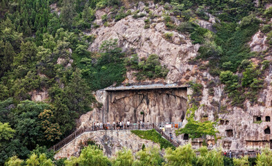 Fototapeta na wymiar Chinese Buddhist monument Longmen Grottoes (Dragon's Gate Grottoes, Longmen Caves) on Yi river