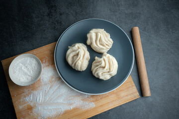 Traditional Chinese food, salt and pepper salt hanamaki. Chinese food Hanamaki on the plate. Chinese food rolls on the board