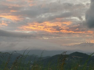 Early sunrise with thick clouds over the mountains.
