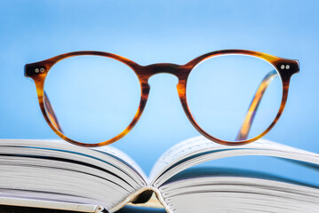 Glasses lying on open book