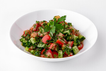 Salad of tomatoes, cucumber, sweet pepper and finely chopped greens with sauce top view. Dishes for delivery, online store. Isolated on a white background.