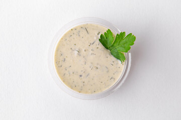 Serving of tar tar sauce in plastic. Topping for dishes for delivery. Isolated on a white background.