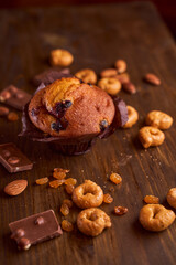 Chocolate maffin on a wooden table with chocolate and tartallini