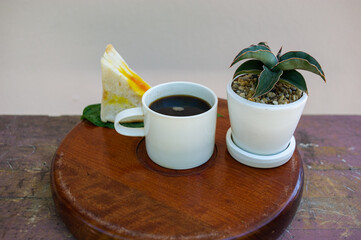 Coffee, sandwiches and ornamental pots on the serving tray