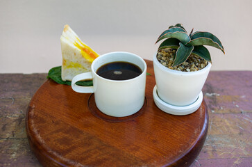 Coffee, sandwiches and ornamental pots on the serving tray